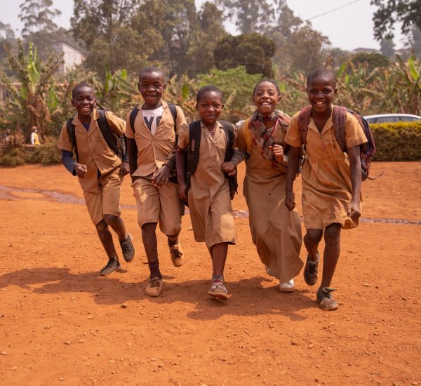 Young group of african children all together at school yard having fun playing holding hands